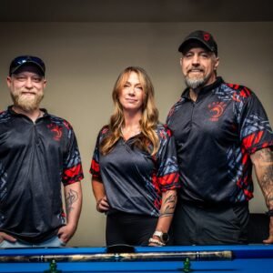Charcoal gray custom pool cues shooting jersey with red accents and front logo.